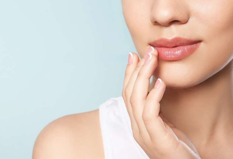 Young woman with sexy lips on color background, closeup