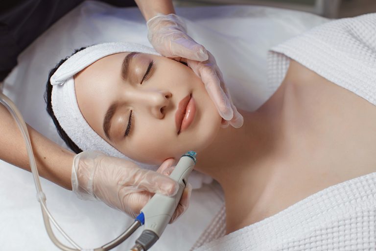 Woman getting hydrafacial treatment on face