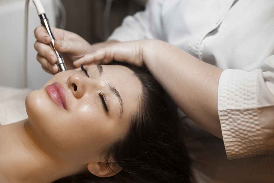 Woman getting microneedling on face