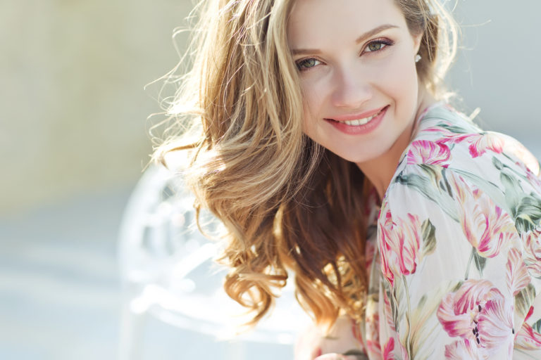 woman with blonde hair smiling at camera