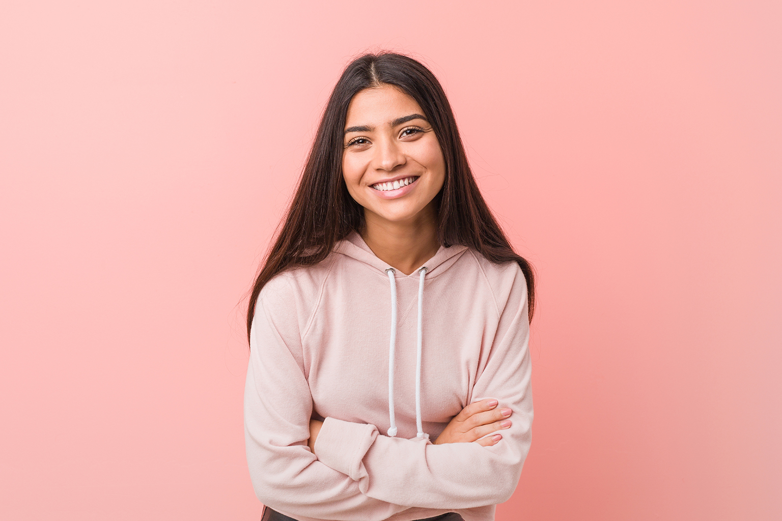 teenage girl on isolated background wearing pink hoodie sweatshirt