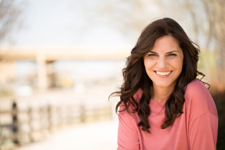 Selective focus of a beautiful mature woman smiling outside